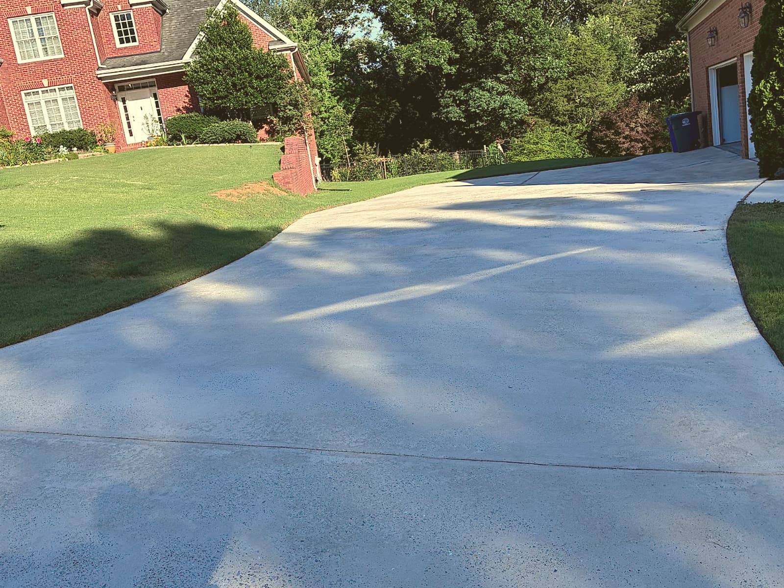 Bright, clean concrete driveway after pressure washing